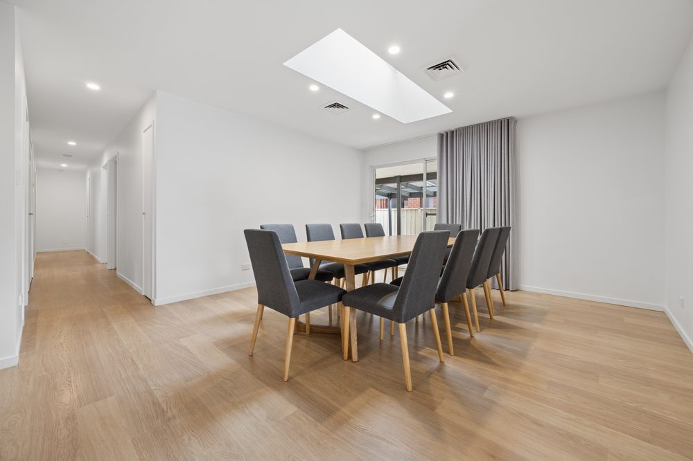 Dining room with a long timber table under a skylight