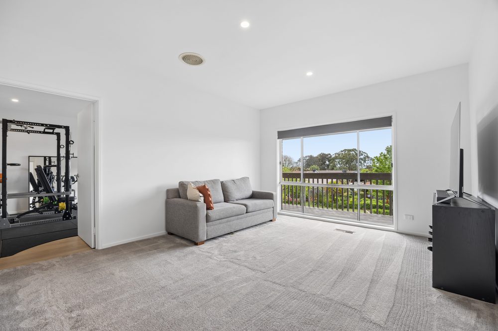 Upstairs rumpus room with a sofa and window