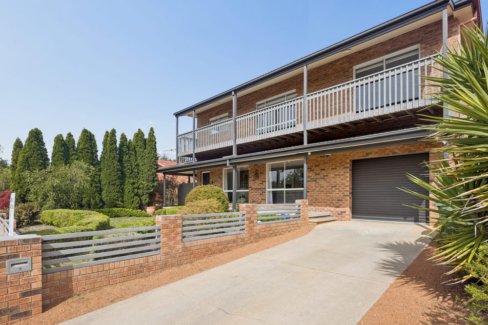 Street view of the house with the driveway and garage