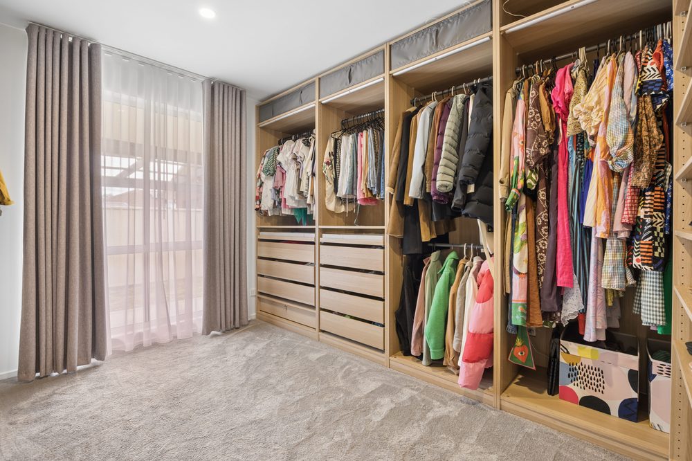 Large walk-in wardrobe with open shelving and hanging space